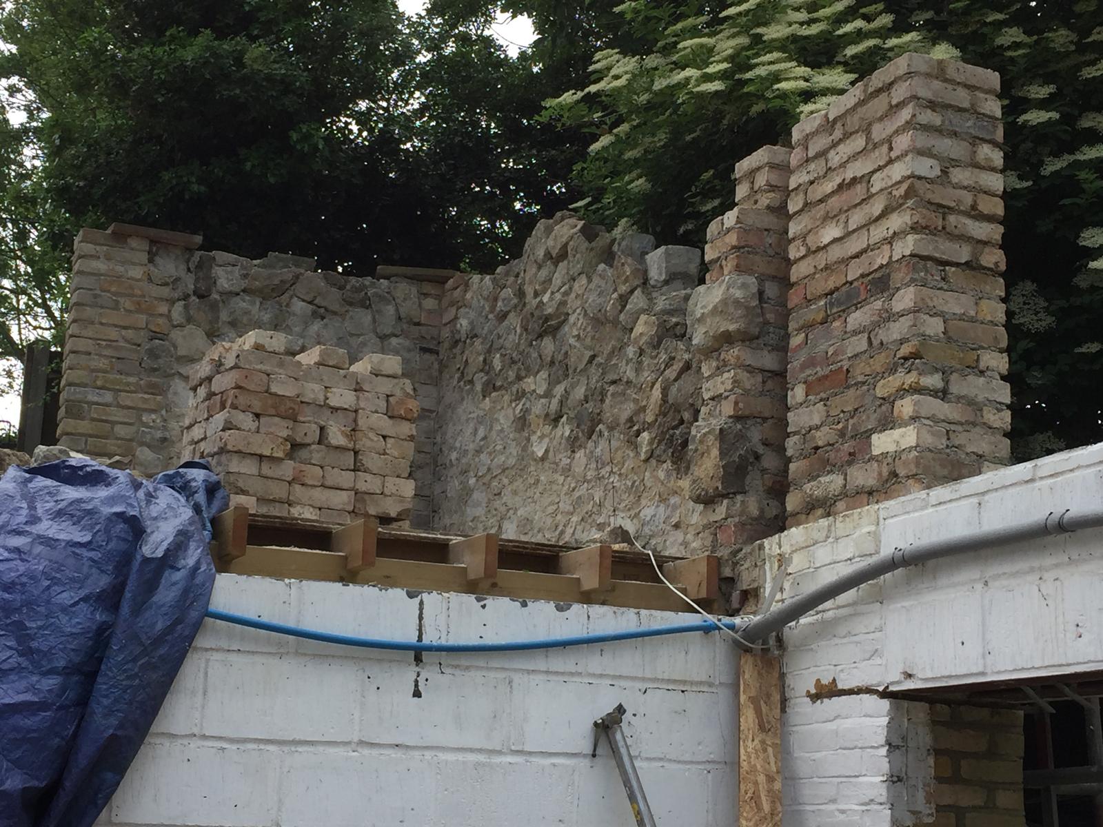 Existing walls ready for extra stone installation on an extension project