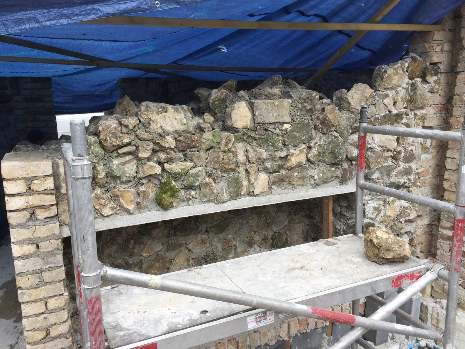 Extension project with natural stone wall installation