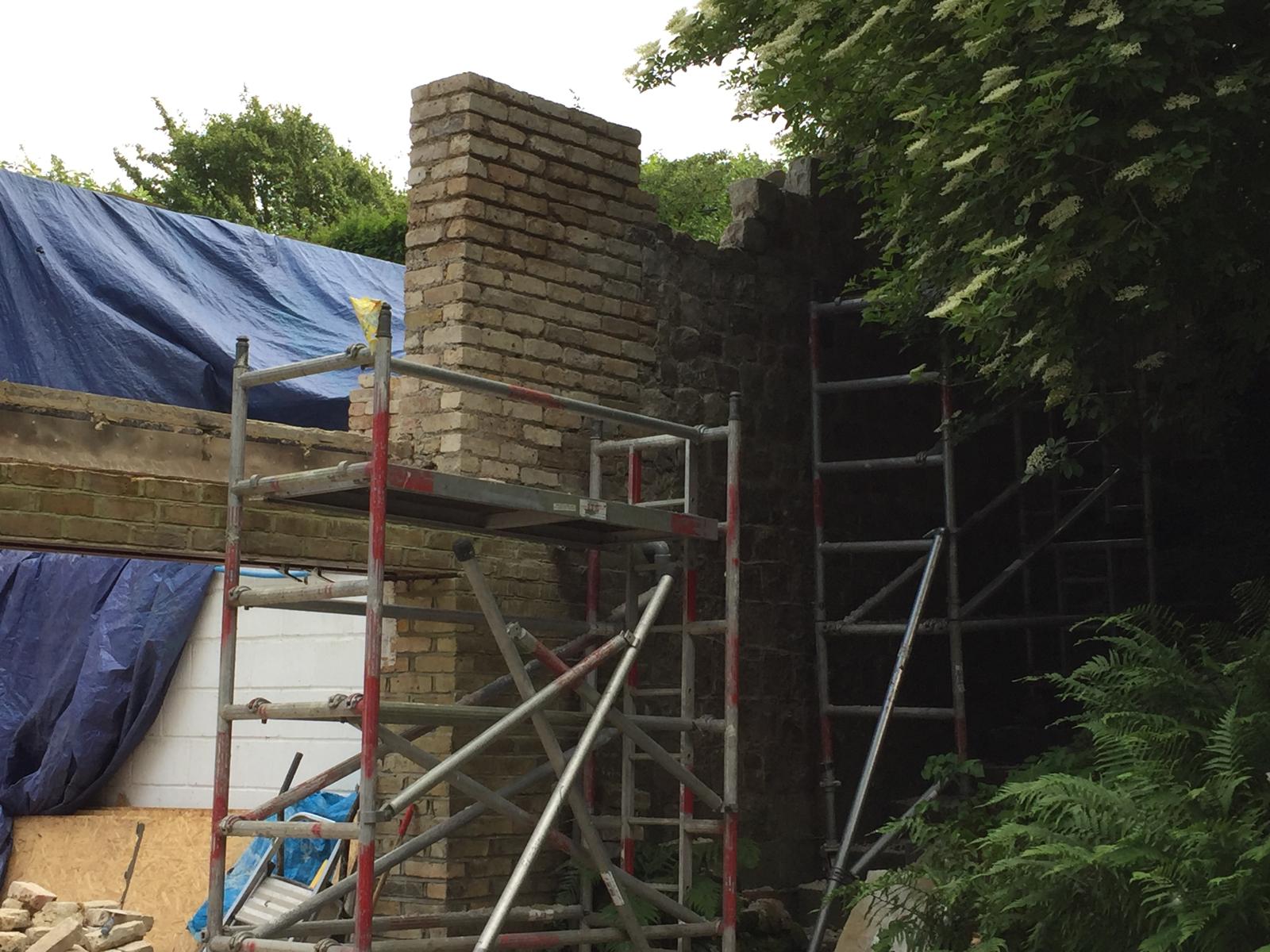 Exterior view of a brick wall installation on an extension project