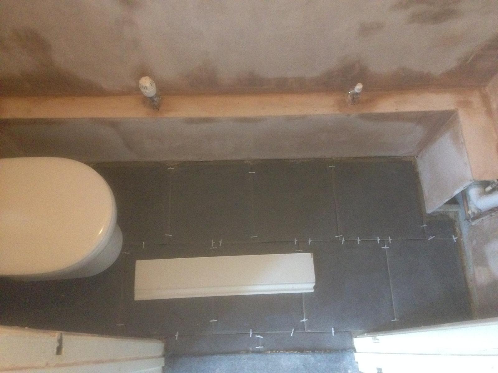 Floor Tile Installation in a toilet for a decorating project 