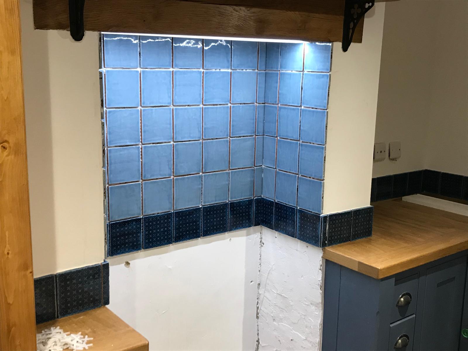 Grey and black wall tile installation kitchen project with lights