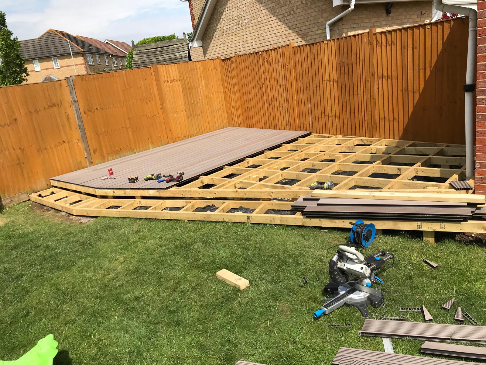 Grey deck boards being installed on wooden frame