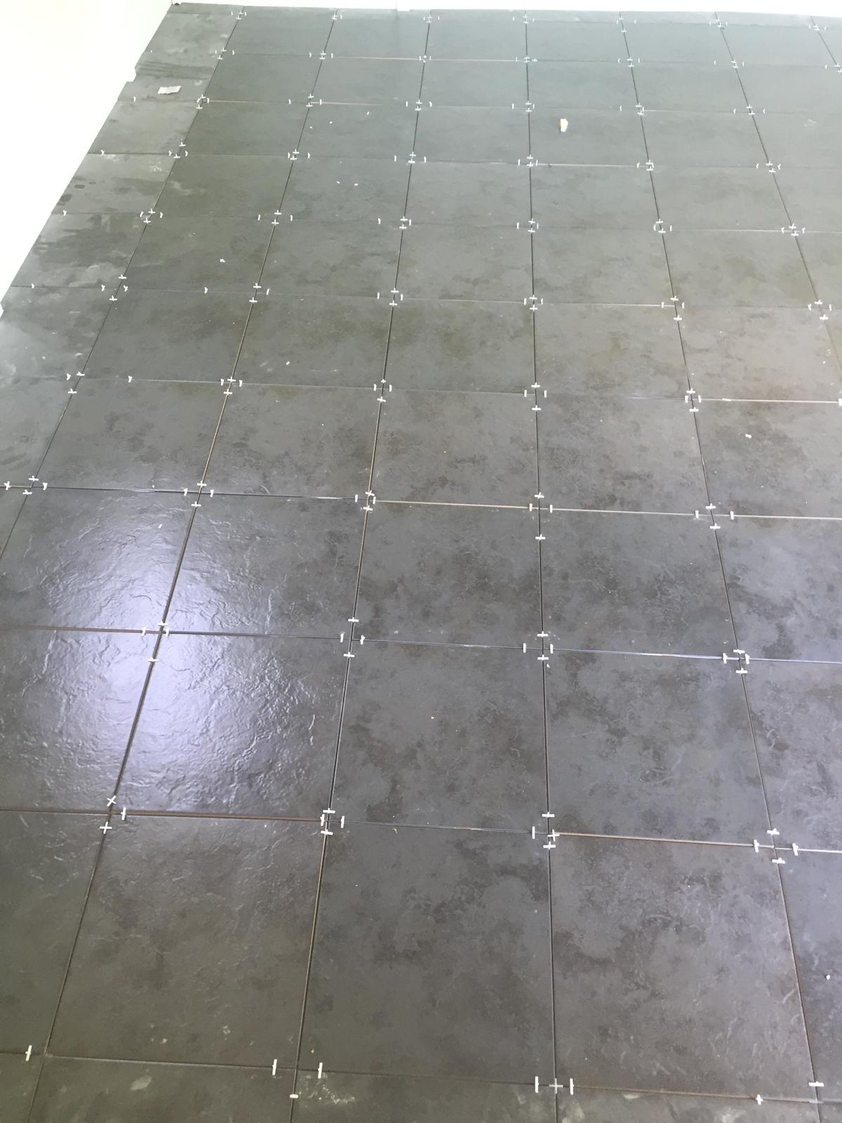 Grey floor tile installation for a local project