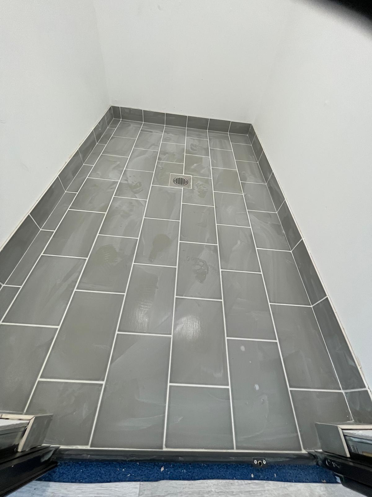 Grey floor tiles laid in wet room for indoor swimming pool