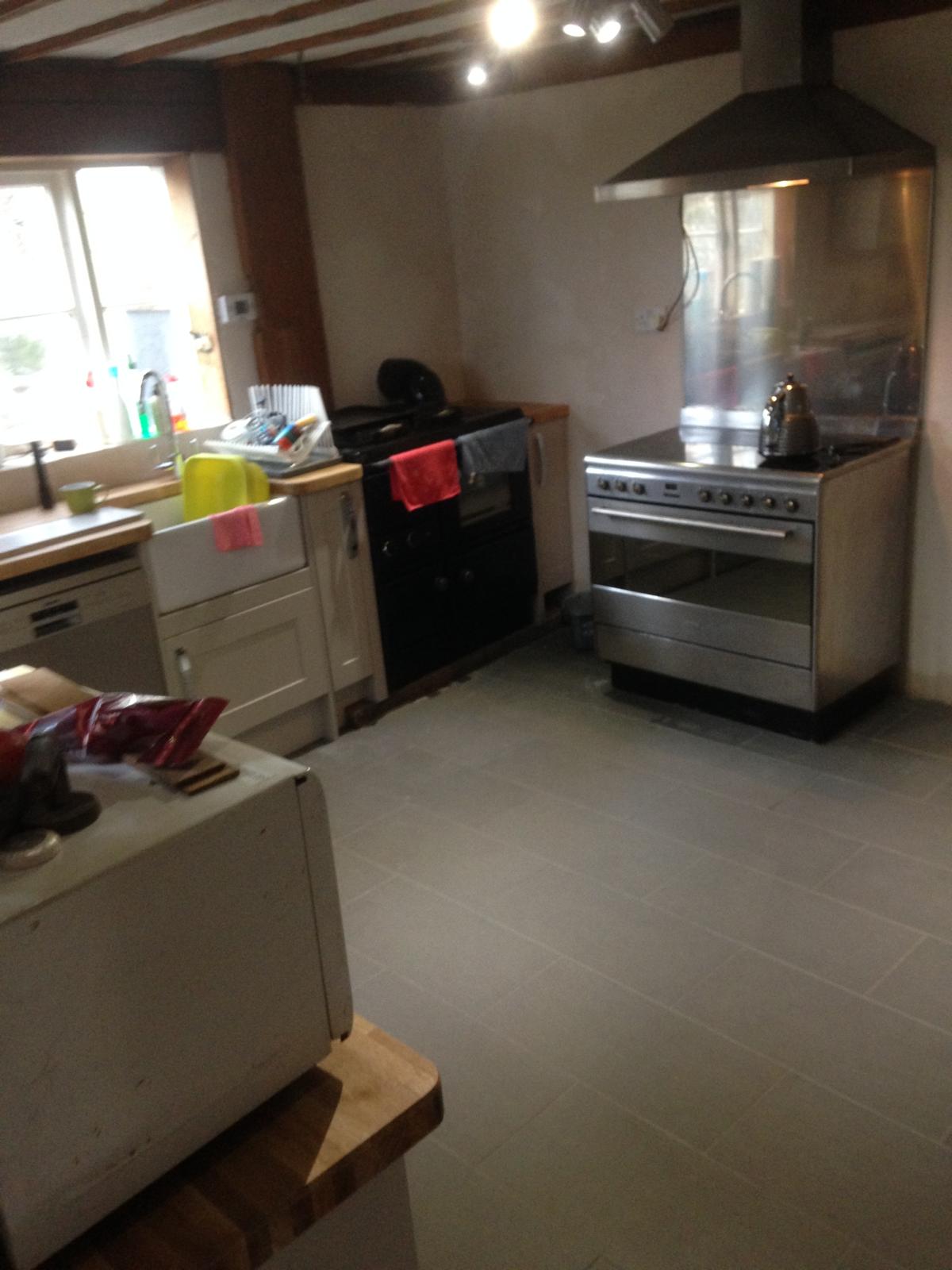 Grey installed floor tiles on a kitchen re-fit project in Kent