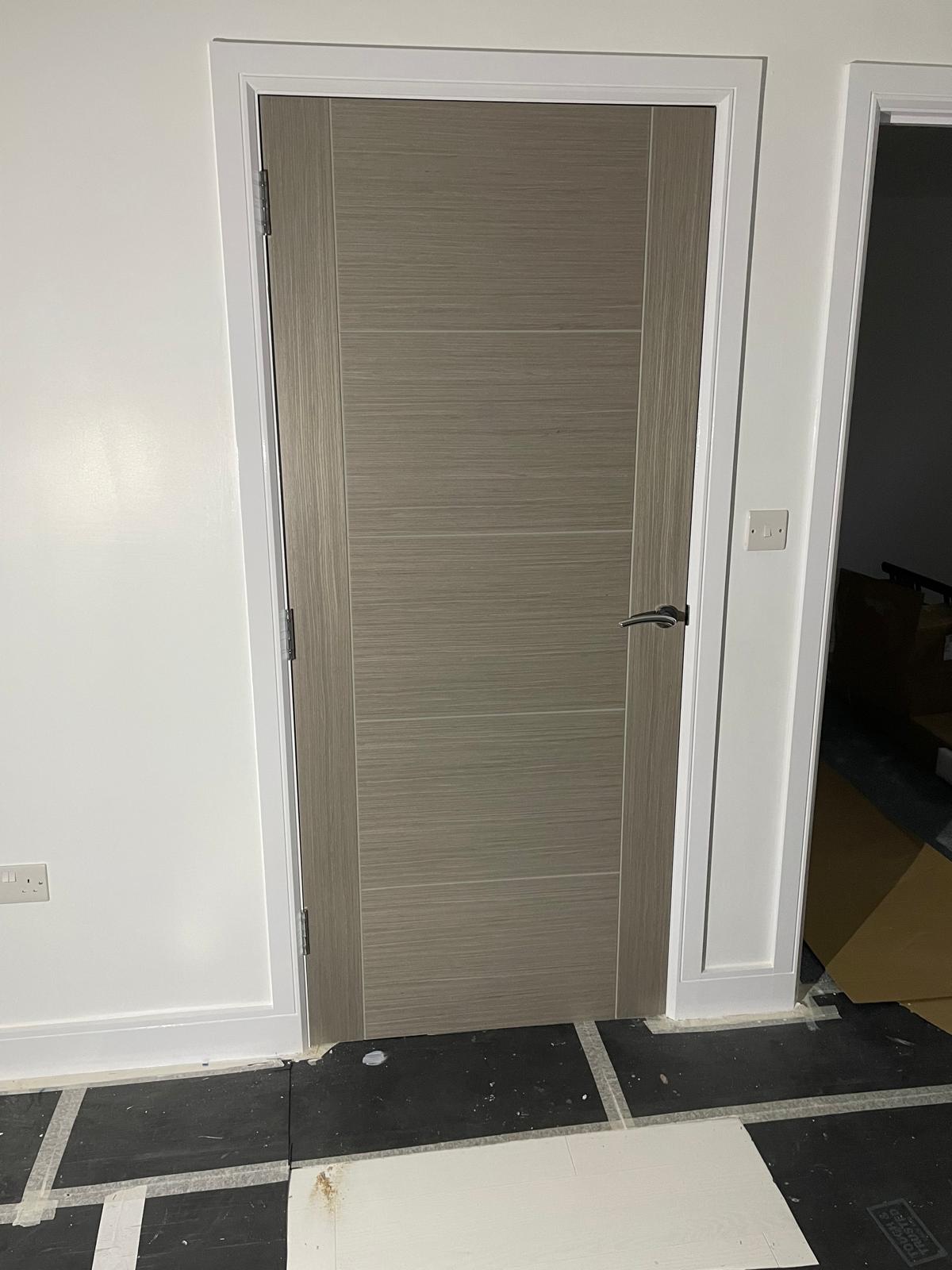 Grey oak wood effect door installation on a conversion project in Kent