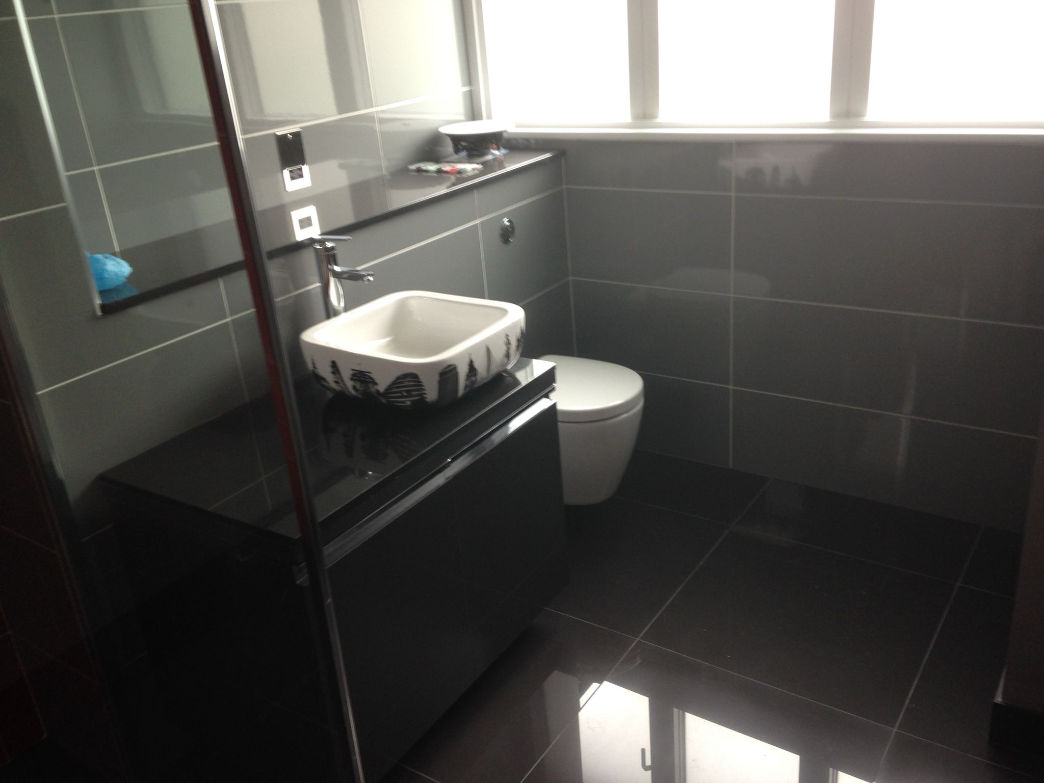 Grey porcelain tile installation in bathroom