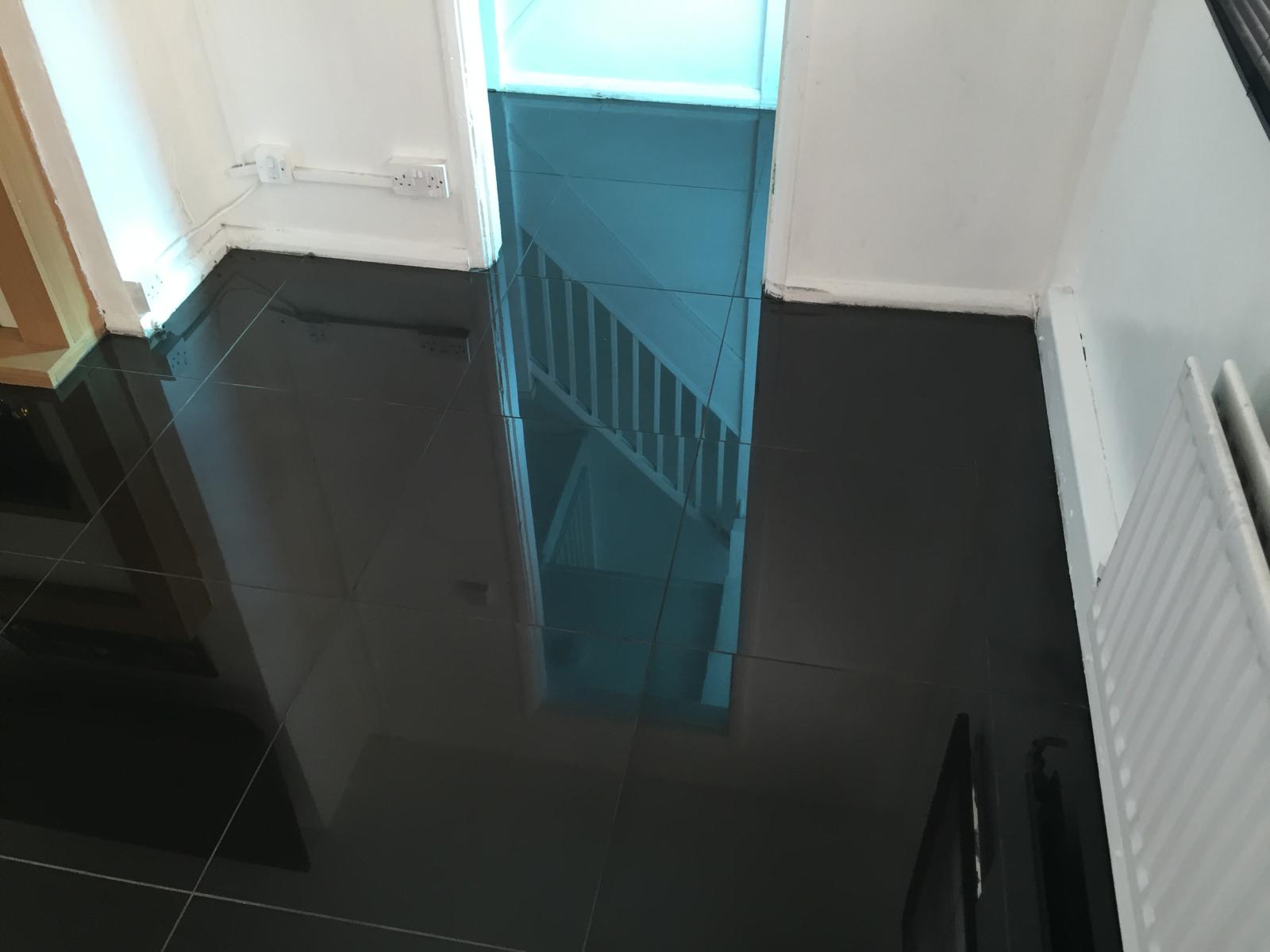 Installation of gloss black floor tiles on a local project in Kent 