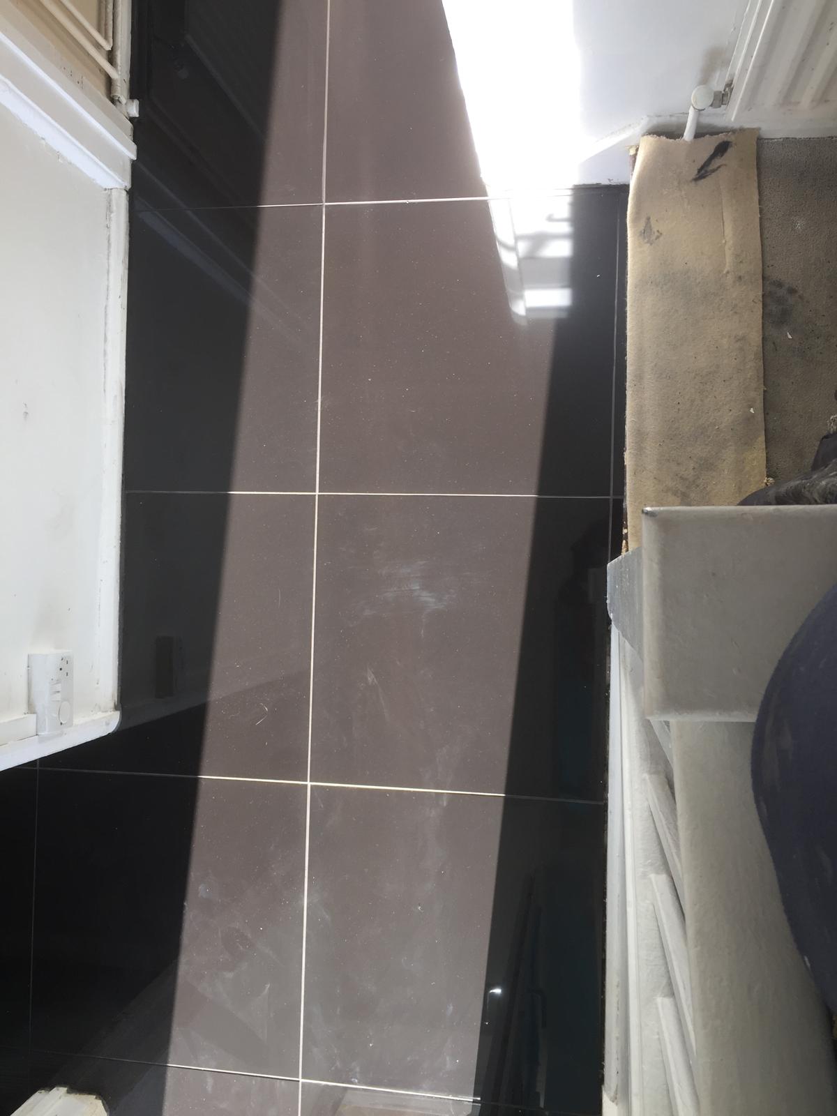 Installation of grey porcelain gloss square tiles on a decorating project in Kent 