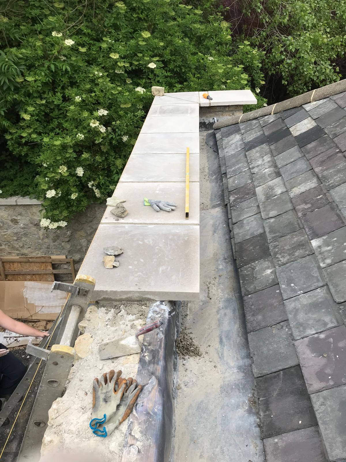 Installation of slabs on natural stone wall part of extension project