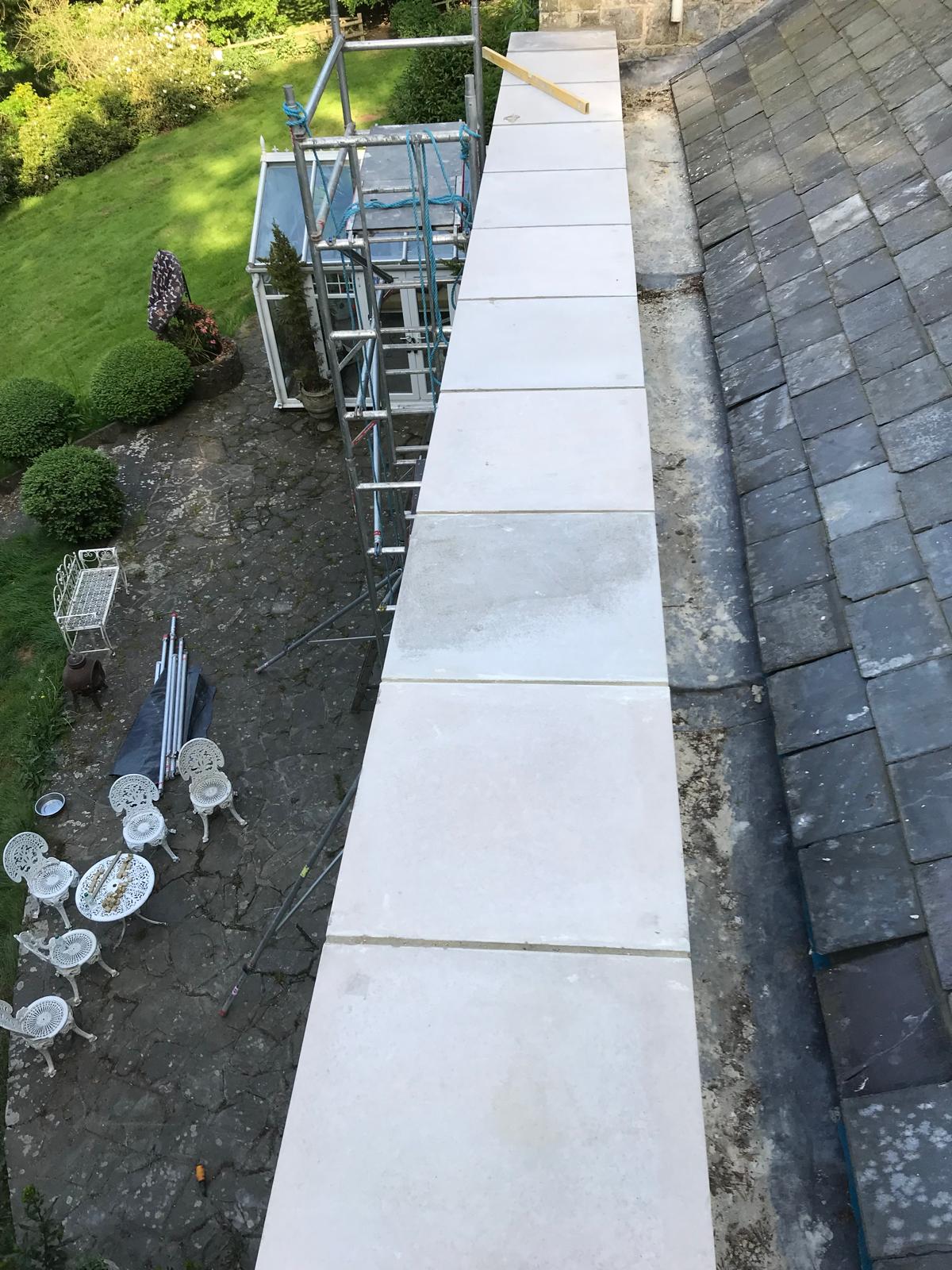 Installation of slabs on top of stone wall installation