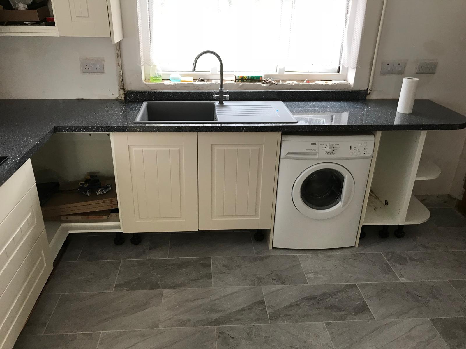 Kitchen cupboard door installed along with sink and worktop for a kitchen installation project