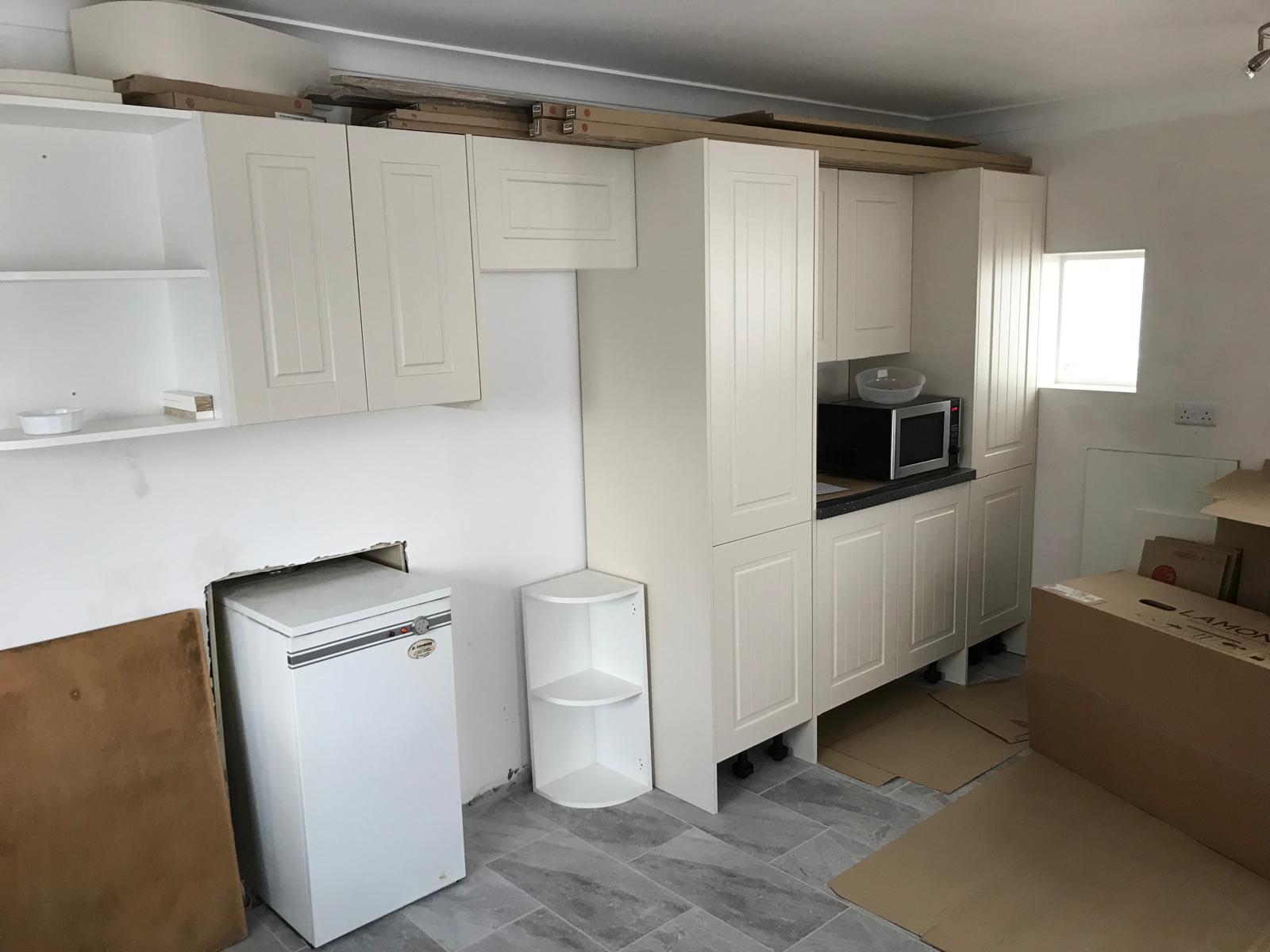 Kitchen cupboard doors being put on for a kitchen installation project