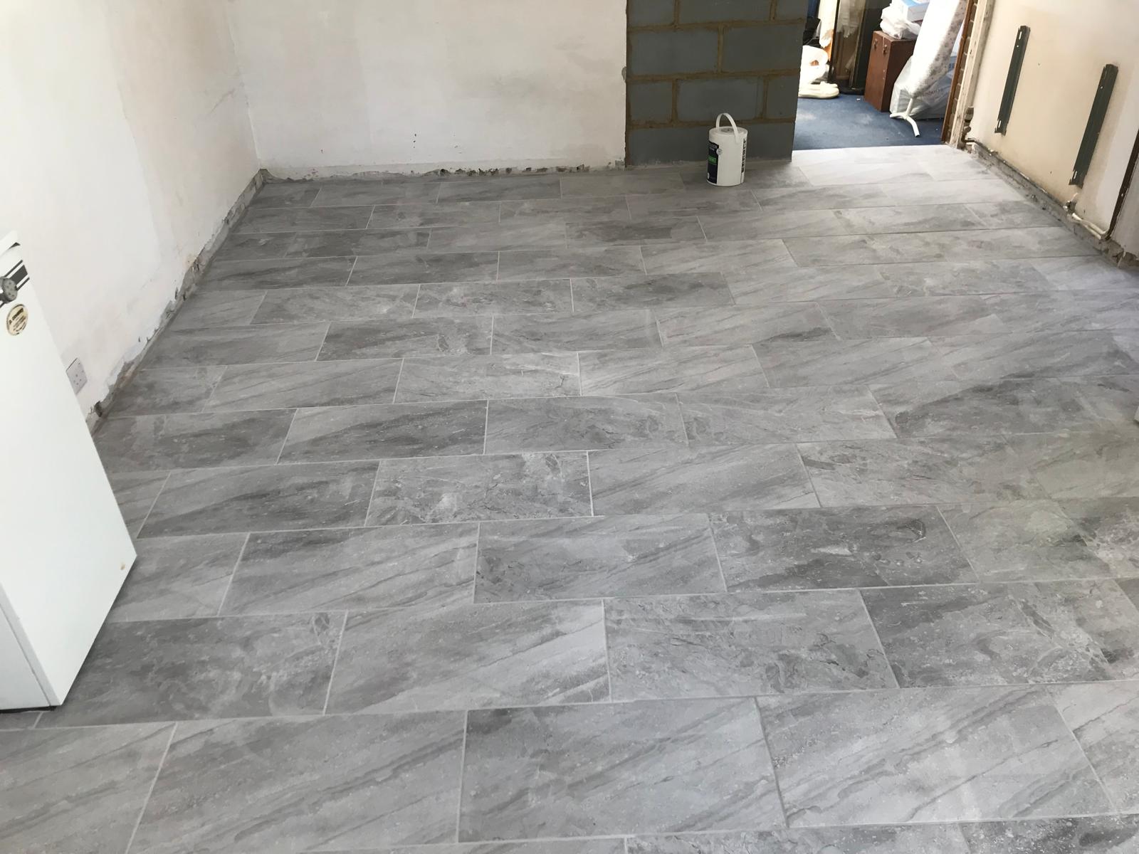 Kitchen installation project with grey tiles installed