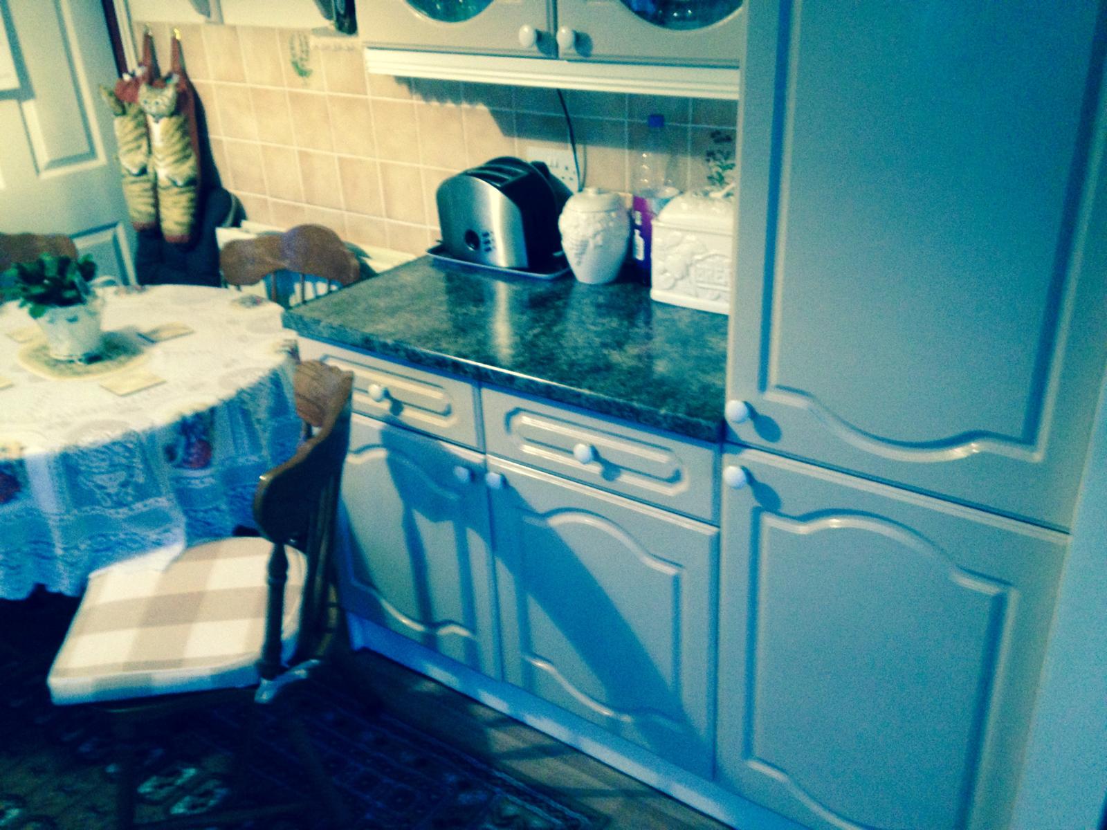 Kitchen installation project with grey cupboards and marble worktop