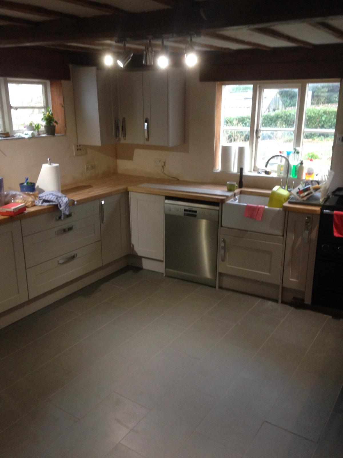 Kitchen re-fit project with grey installed floor tiles