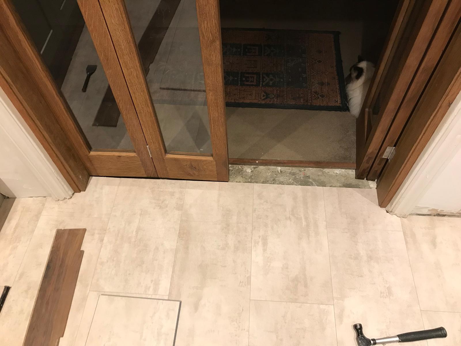 Laminate floor installation around door frame on kitchen extension project