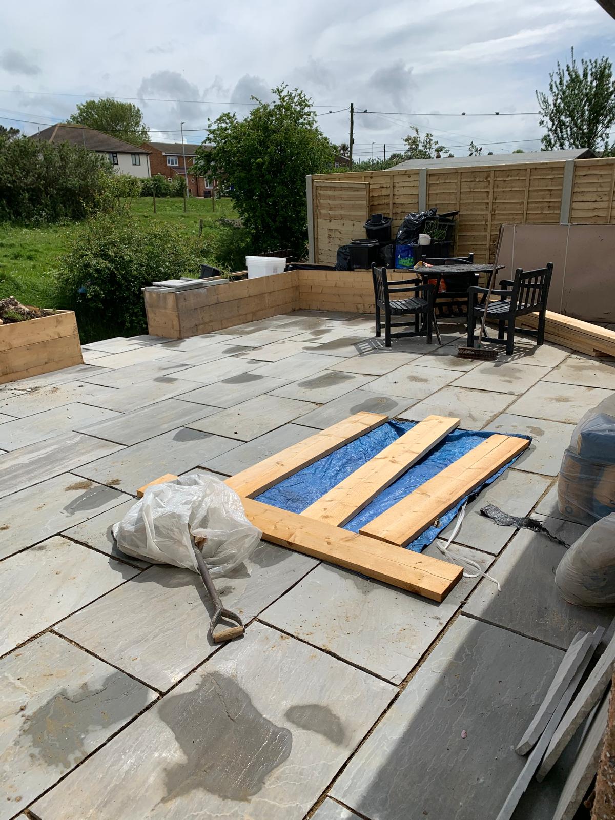 Large grey patio installation for a local landscaping project