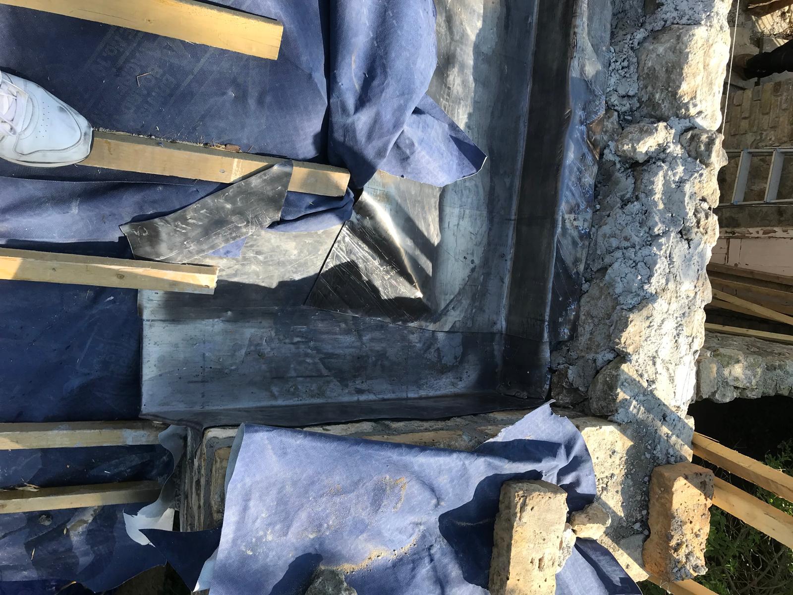 Lead installation on a roof on stone wall extension project
