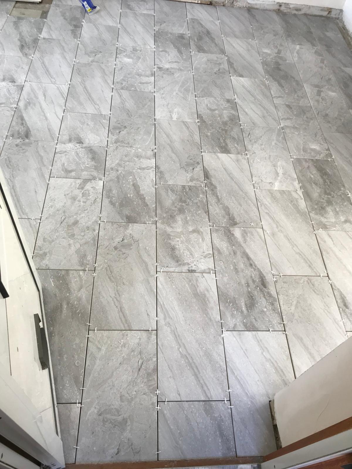 Light grey tile installation on a kitchen project