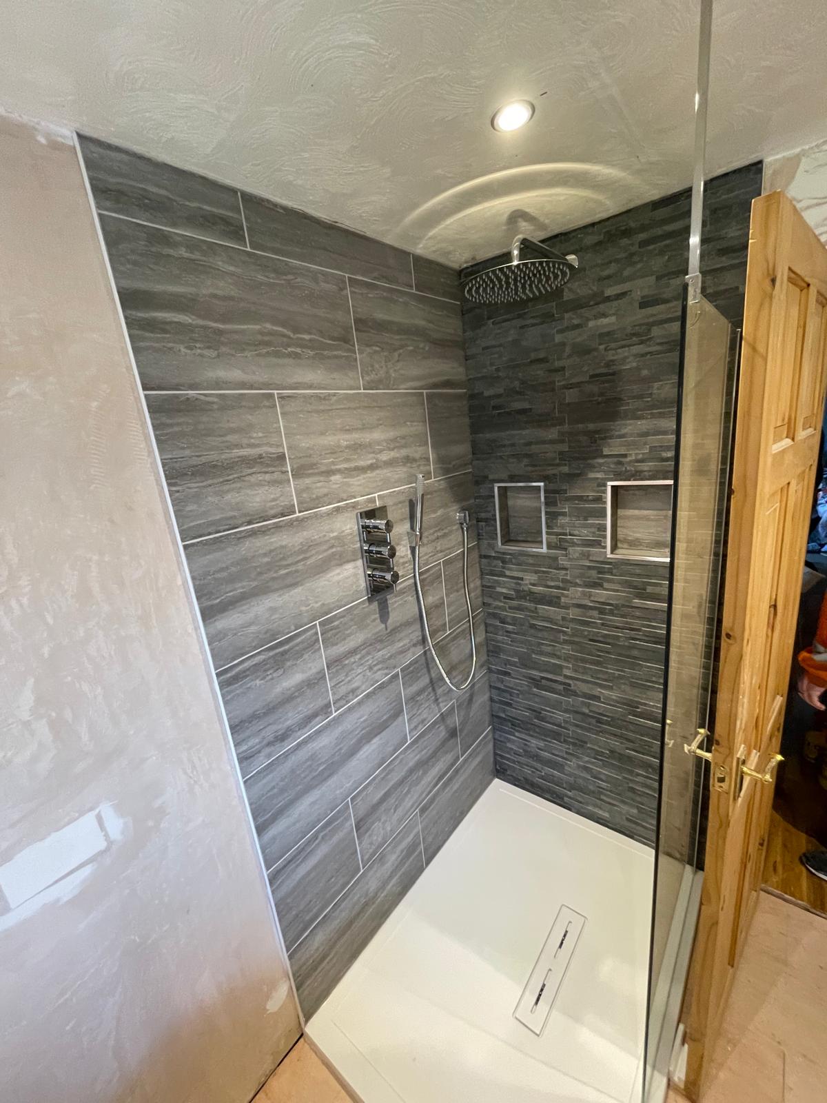 Local bathroom project with slate effect wall tiles in shower area 