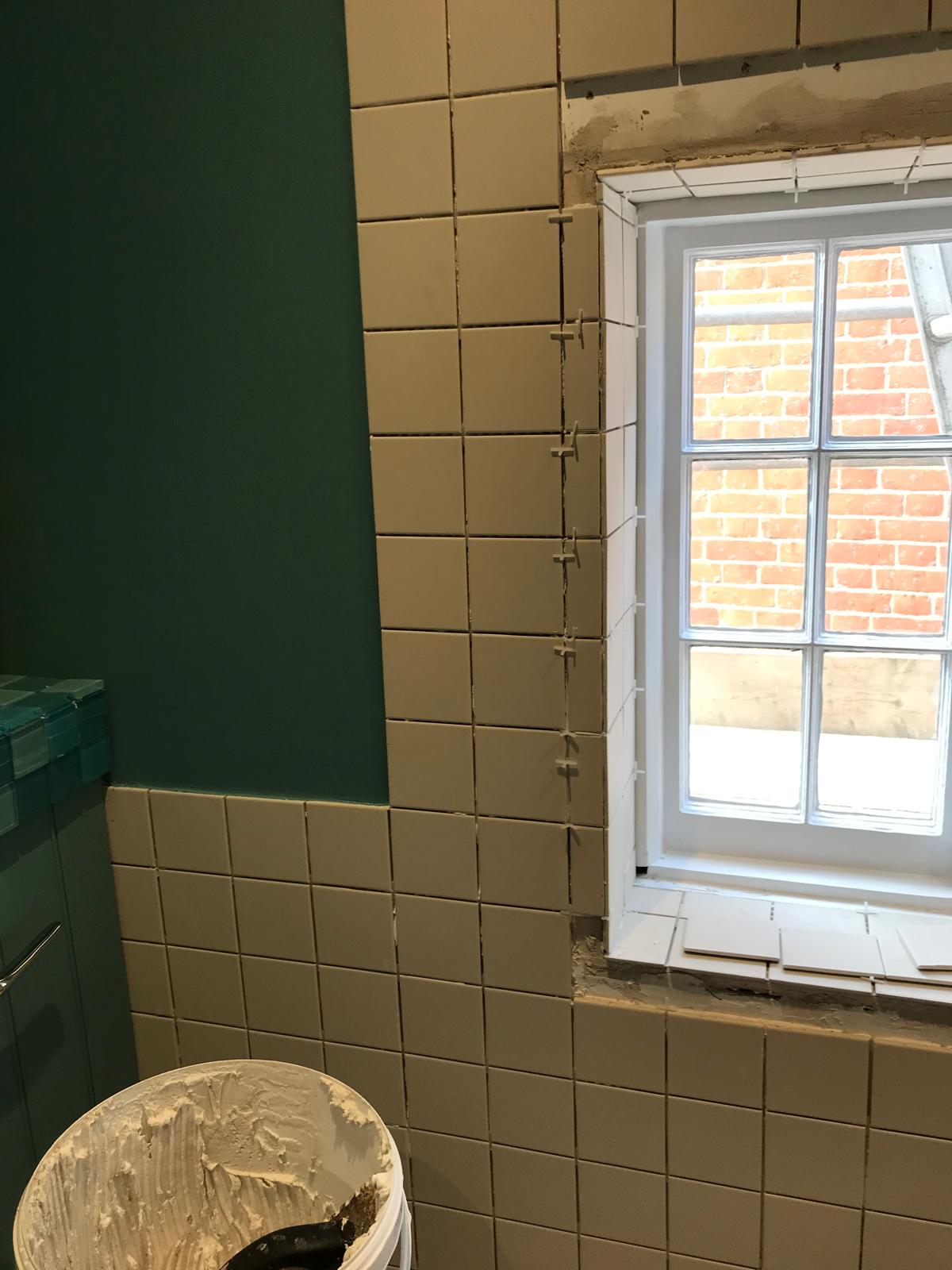 Local bathroom project with white tile installation
