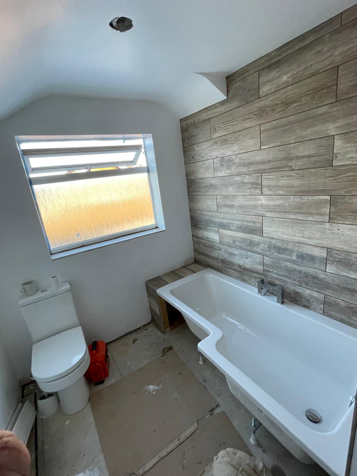 Local bathroom project with wooden effect wall til installation