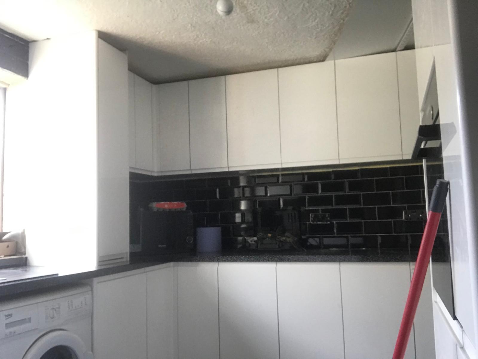 Local kitchen project black gloss wall tile installation