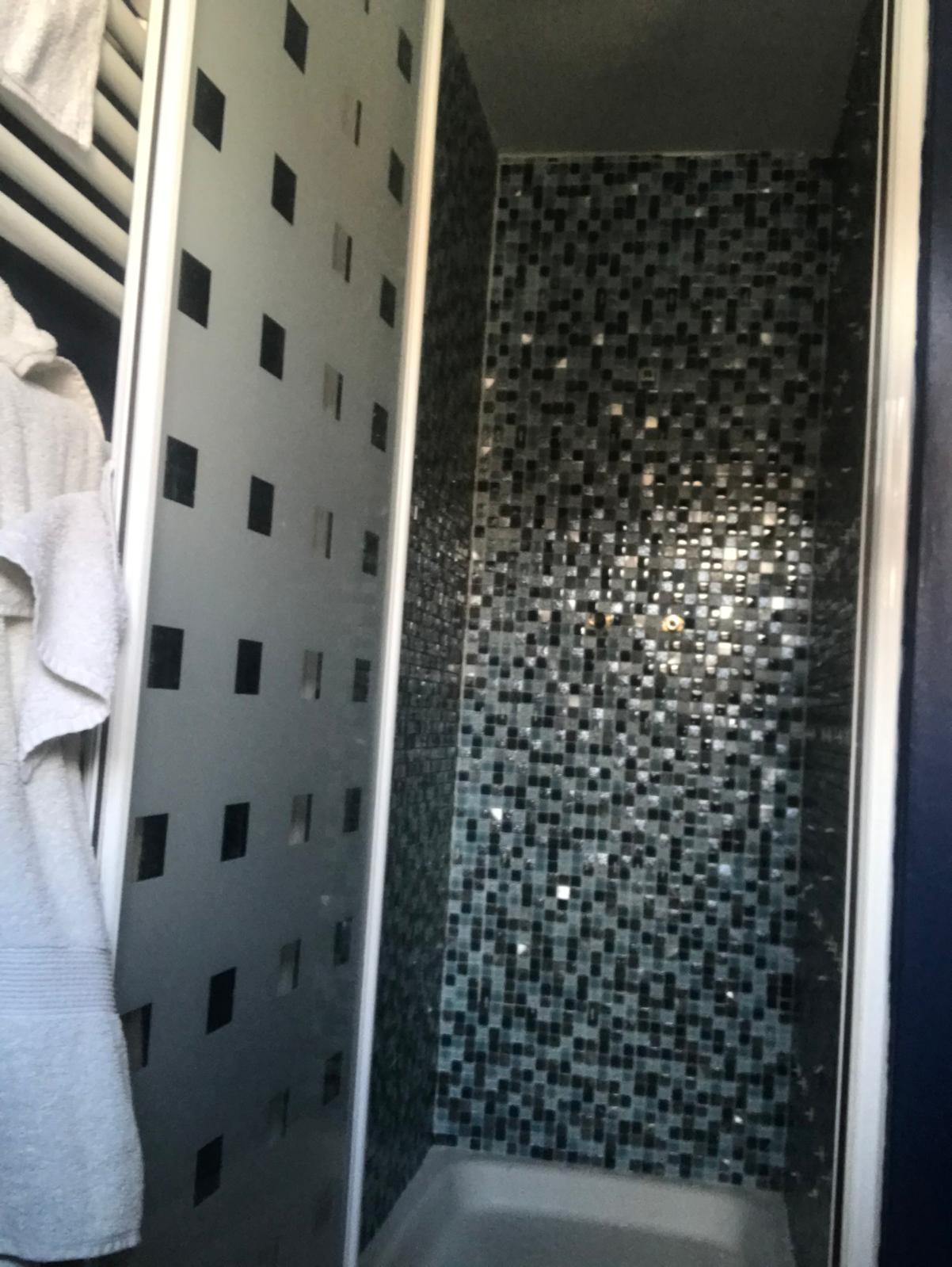 Mosaic wall tiles installed in a shower for a local bathroom project