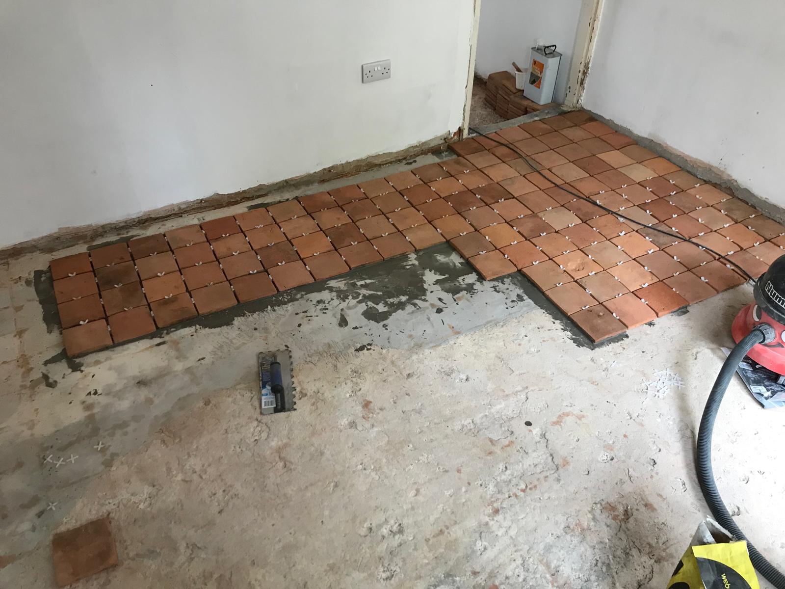 Natural square terracotta floor tile installation for a local decorating project in Kent