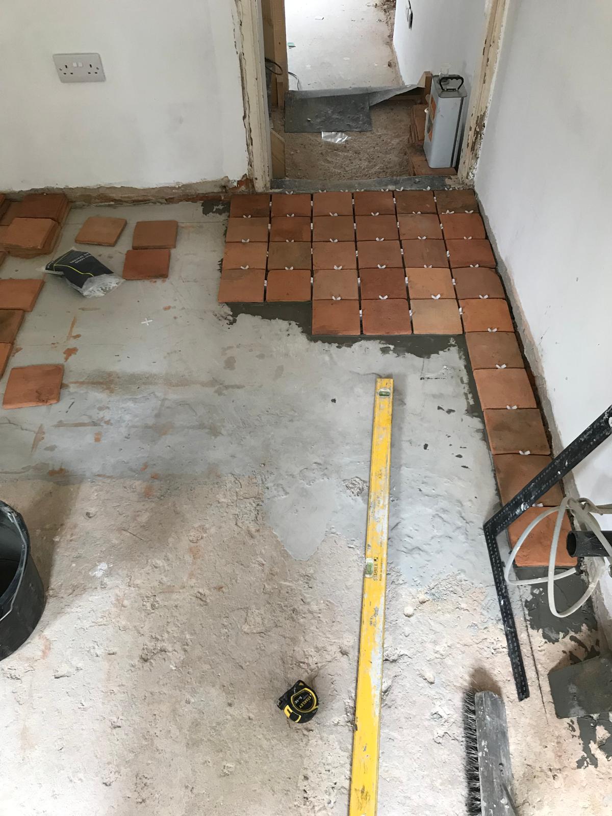 Natural square terracotta tile installation for a local decorating project