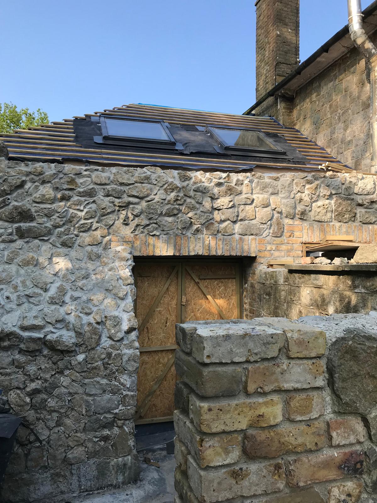 Natural stone extension with roof installation
