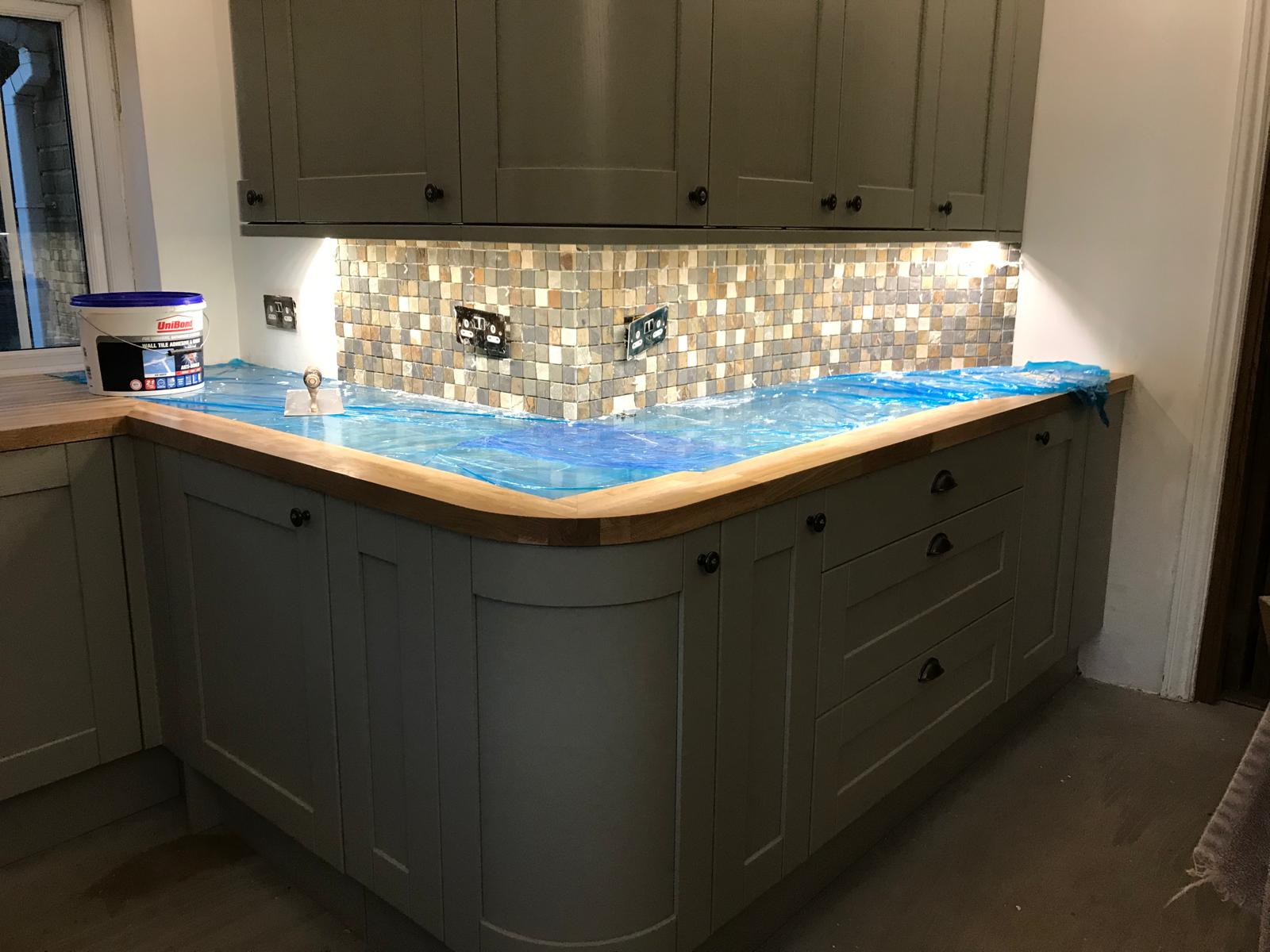 Natural stone mosaic wall tile installation on a local kitchen extension project