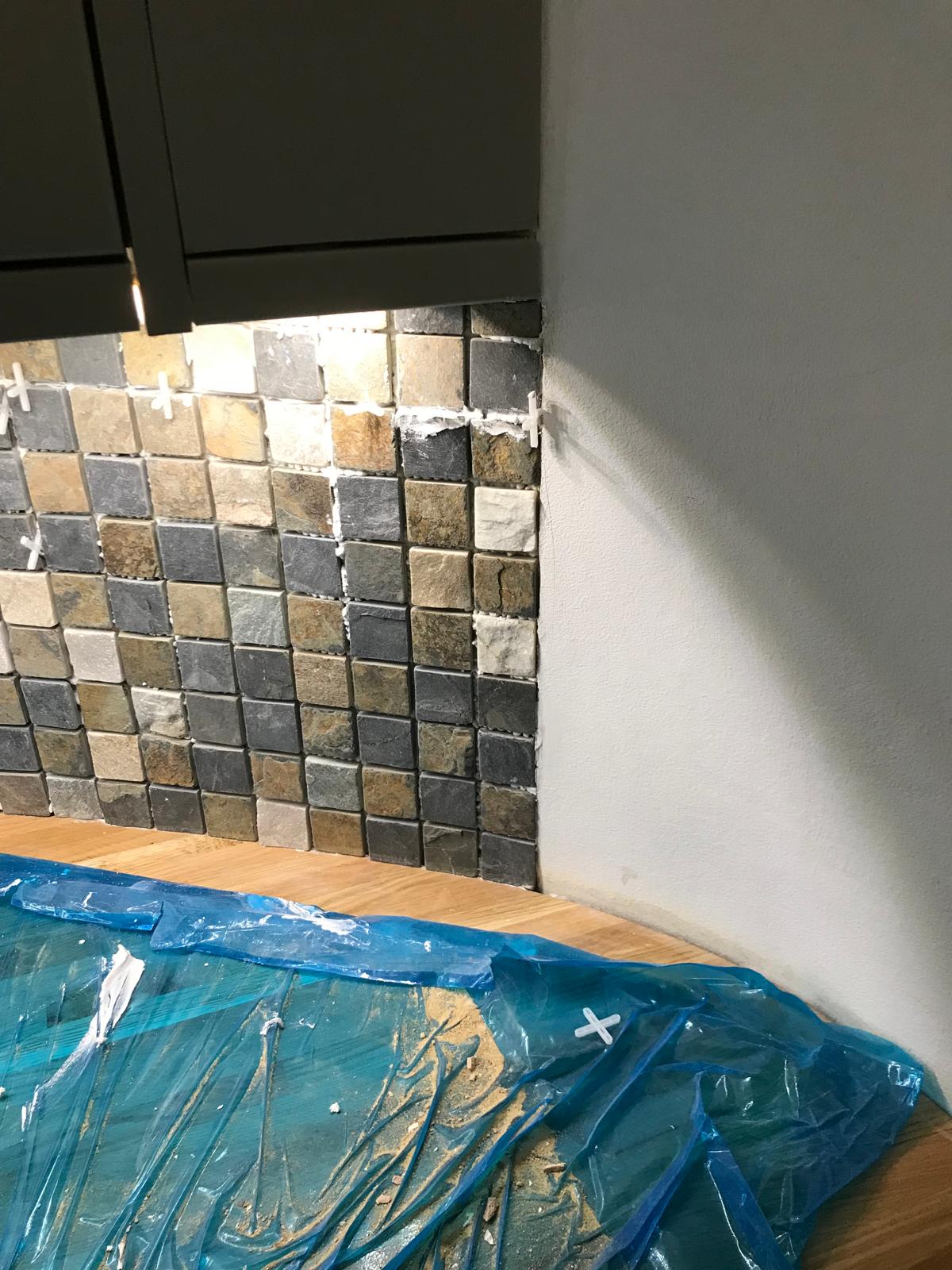 Natural stone mosiac wall tile installation on kitchen extension project