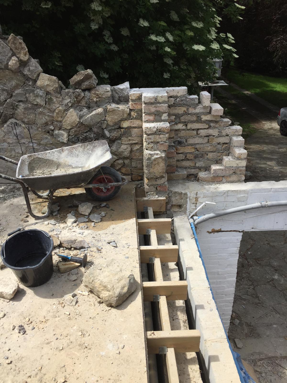 Natural stone wall installation first stages of an extension project