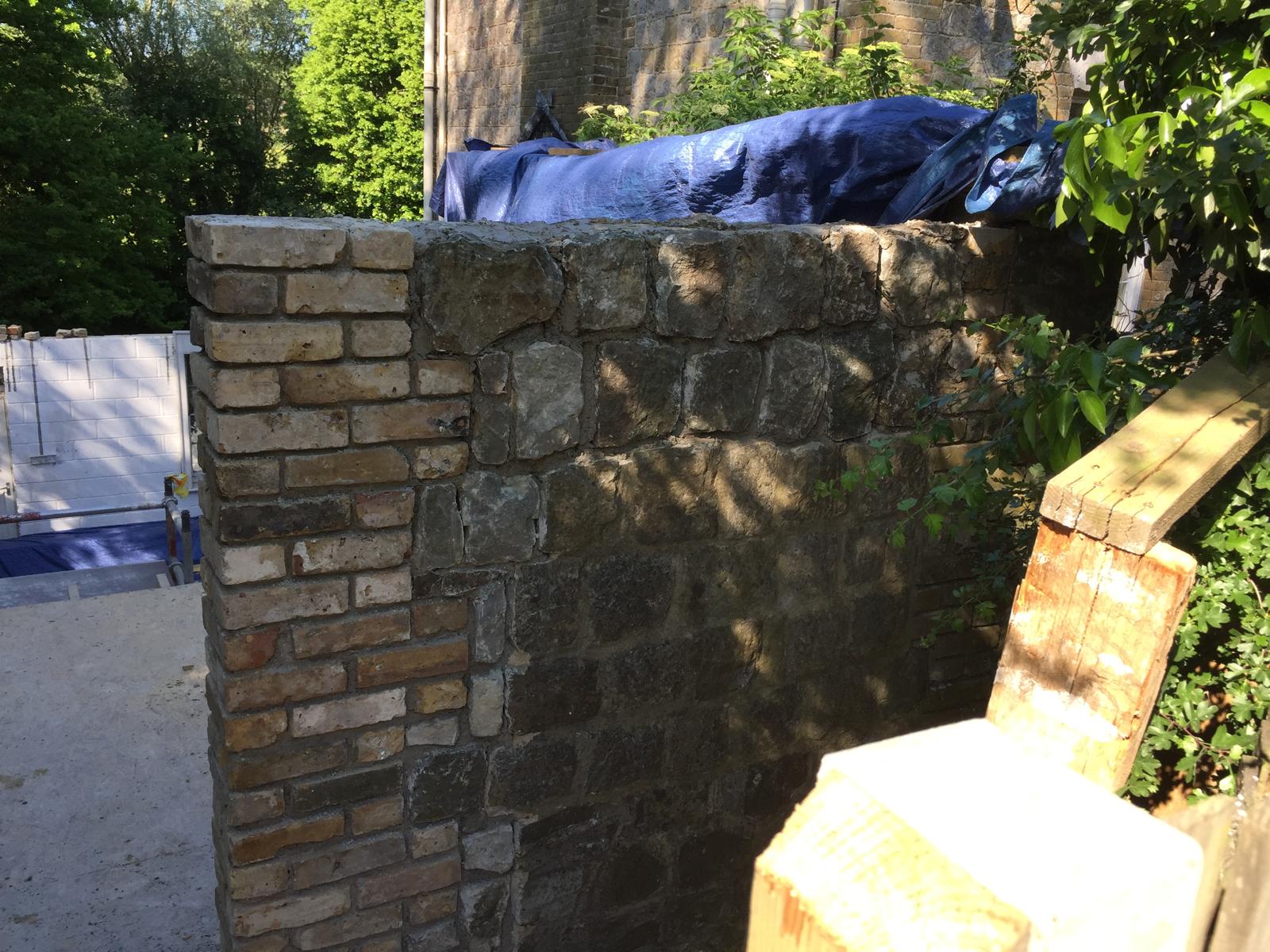 Natural stone wall installation on an extension project