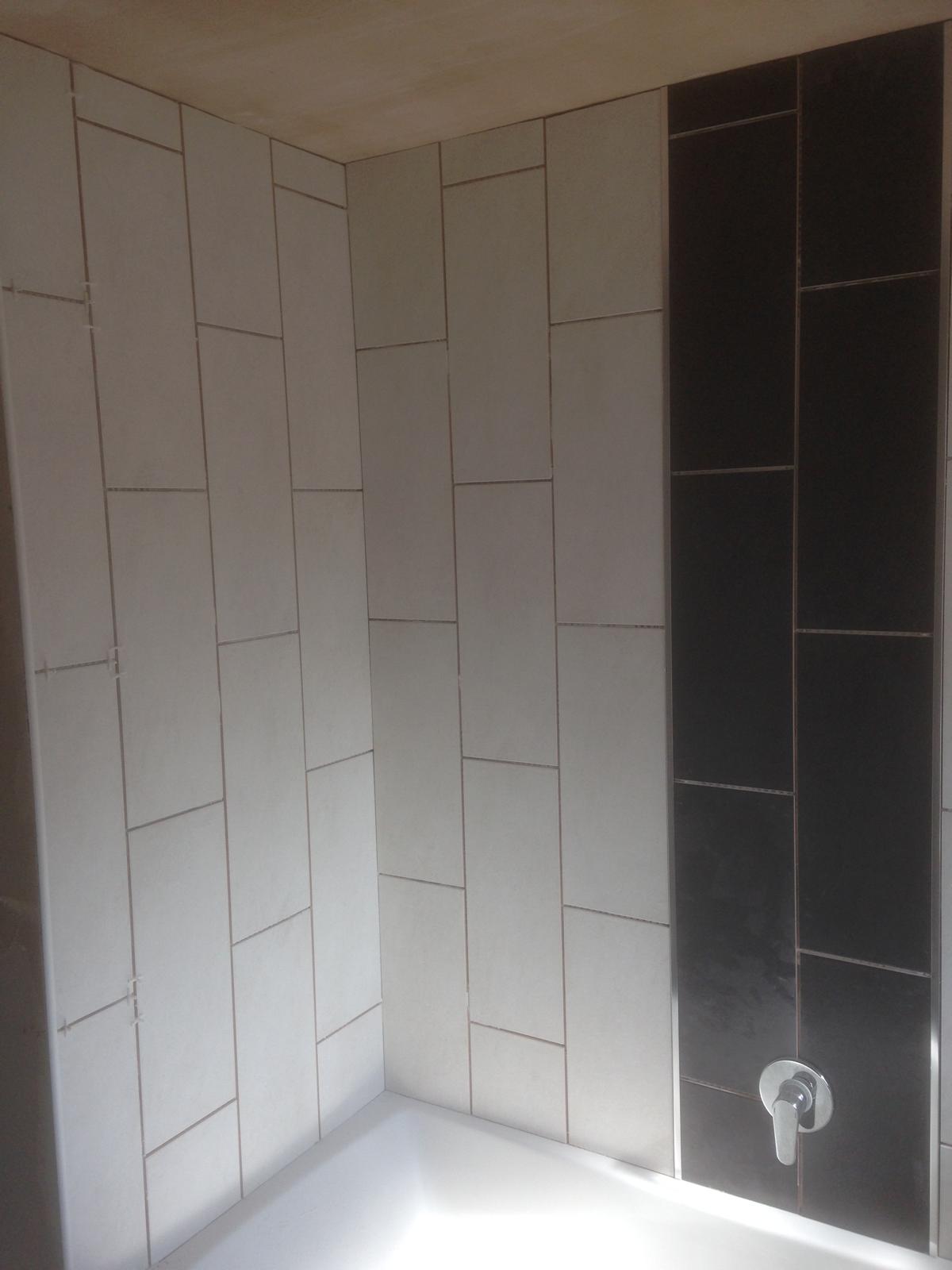 Over the bath wall tile installation with black tile feature 