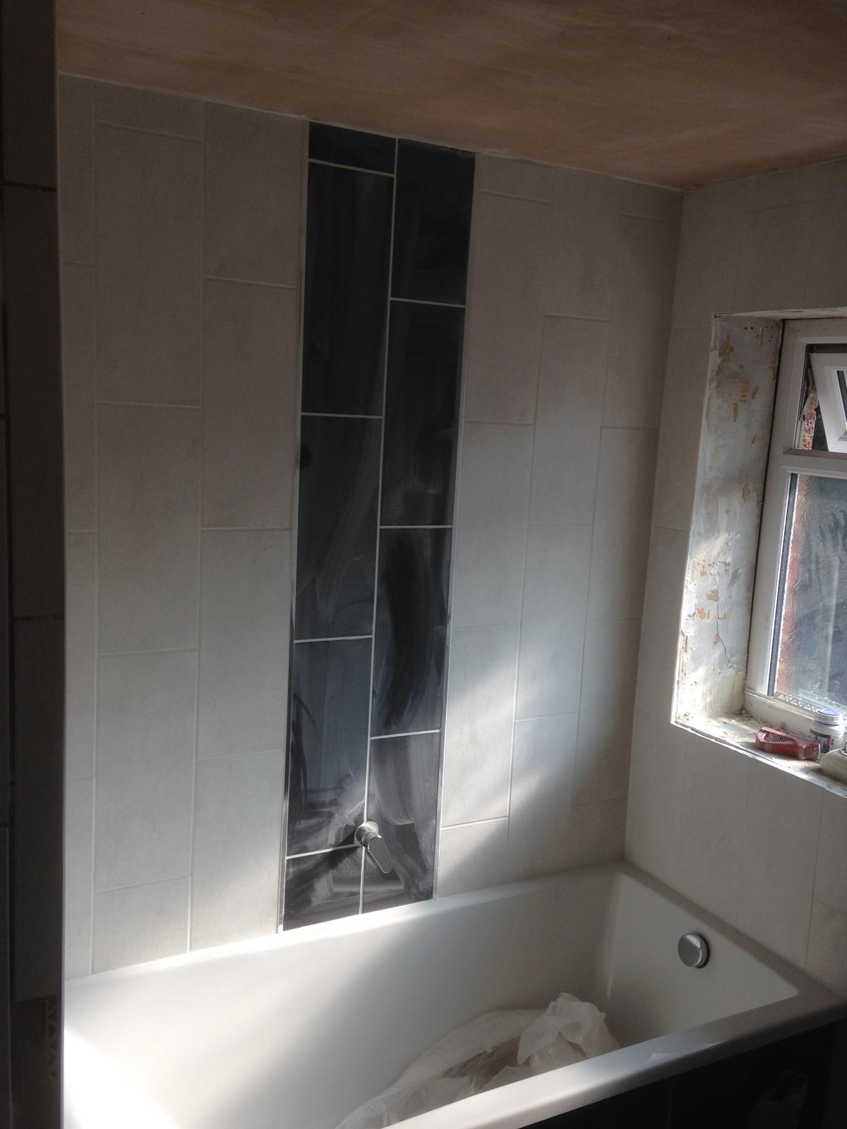 Over the bath white rectangle wall tile with black feature for a bathroom project in Kent 