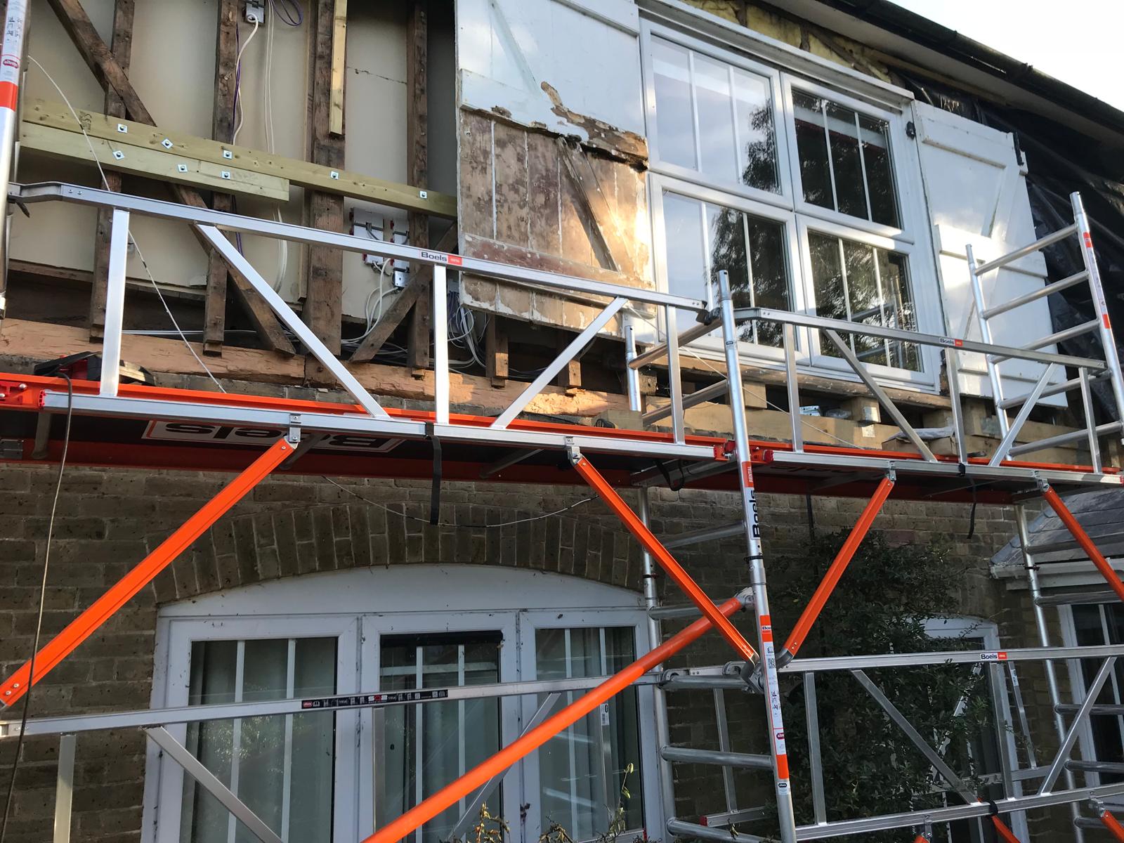 Paint striping the window shutters for a house exterior cladding project