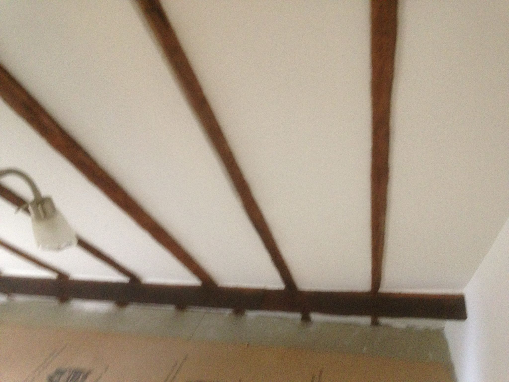Painting and Decorating project with feature beams and tilted roof wall