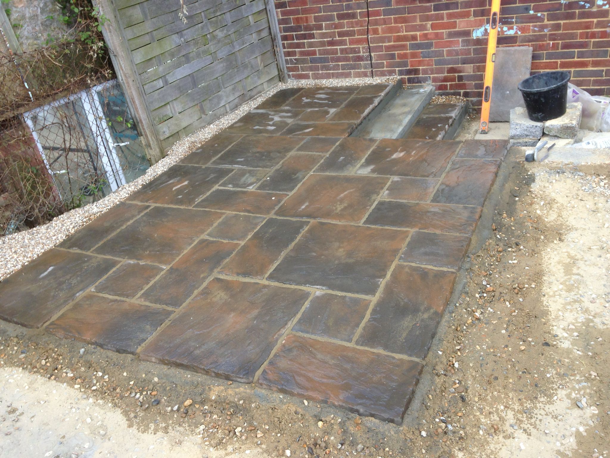 Patio installation with multi sized slabs for a local landscaping project