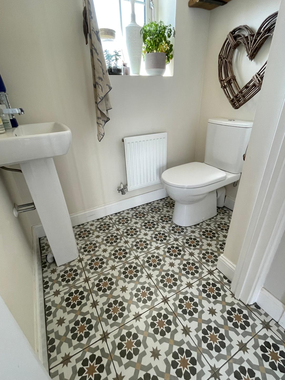 Patterned floor tile installation in bathroom area for a decorating project in Kent