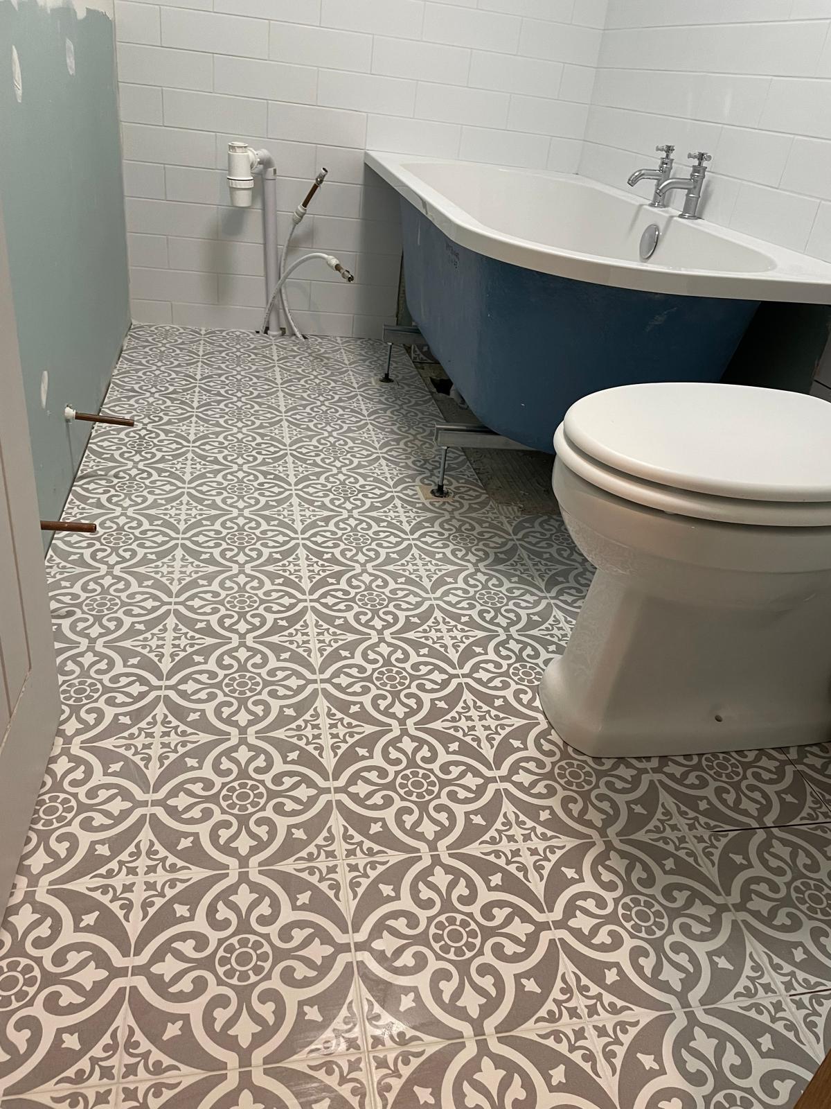 Patterned floor tile installation on a local bathroom project in Kent