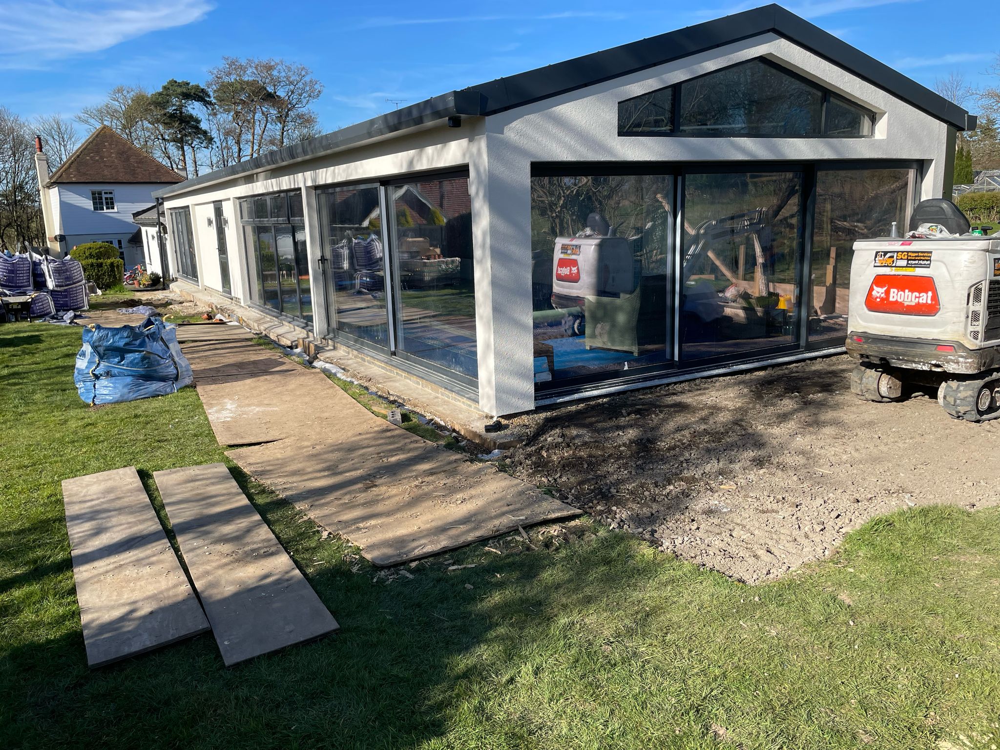 Preparation for slabs to be laid around the swimming pool building.