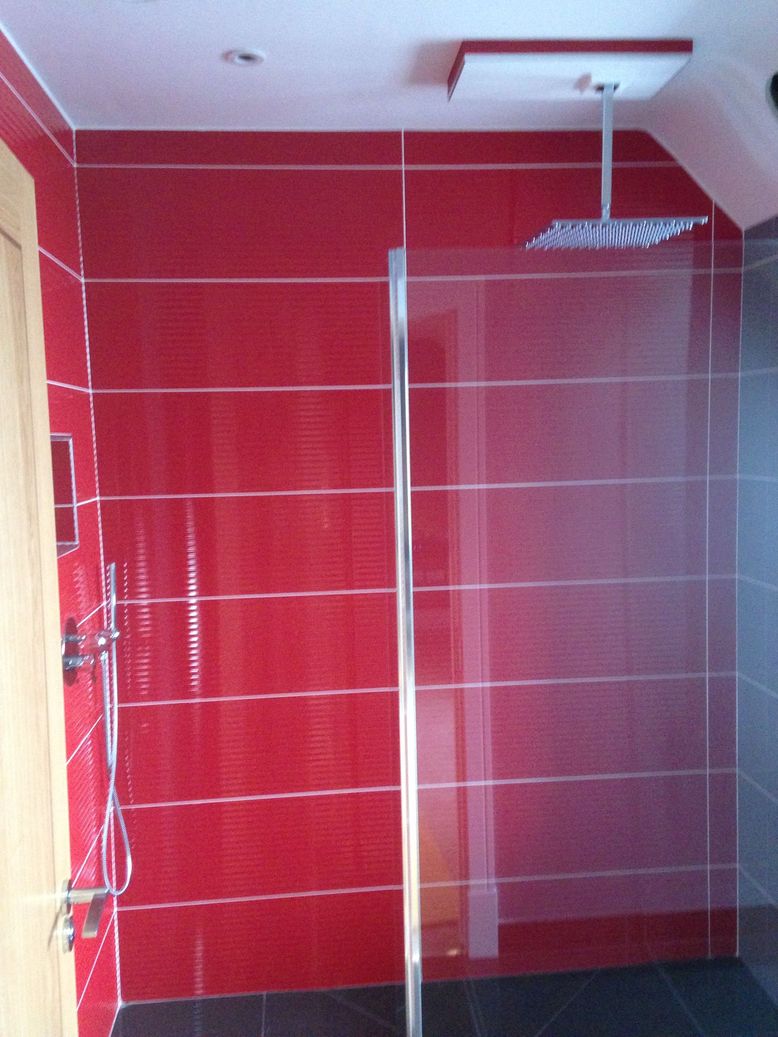Red gloss tile installation on a bathroom project in Kent