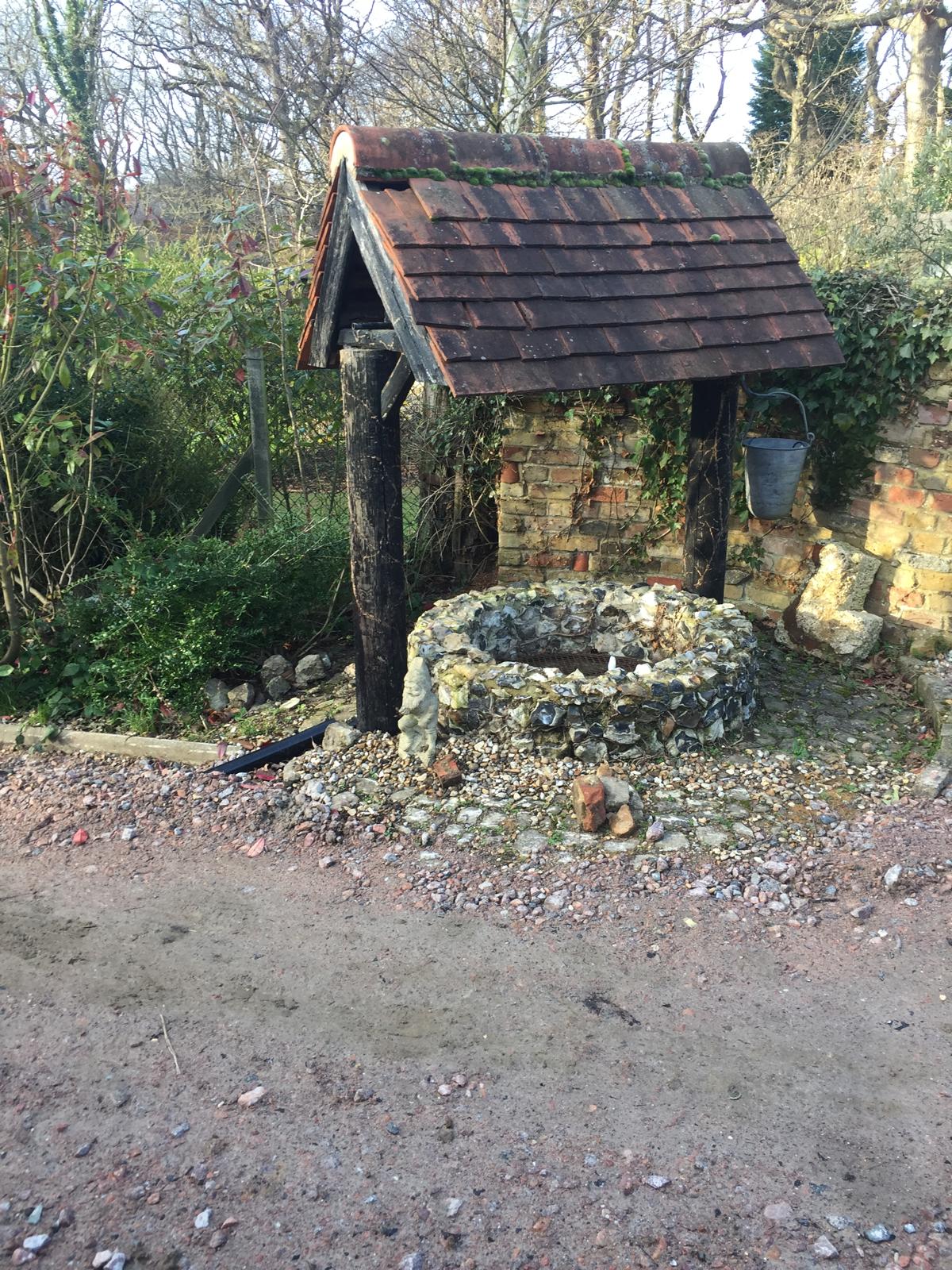 Roof repair project on a nautral stone well