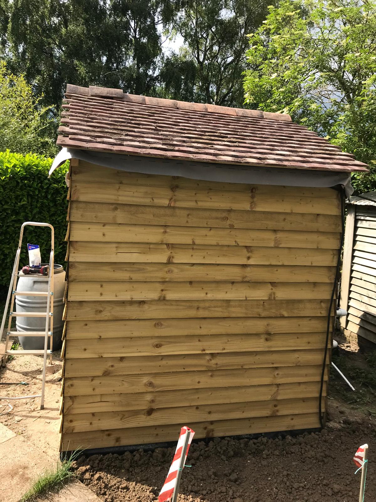 Roof tile installation on local custom shed build project