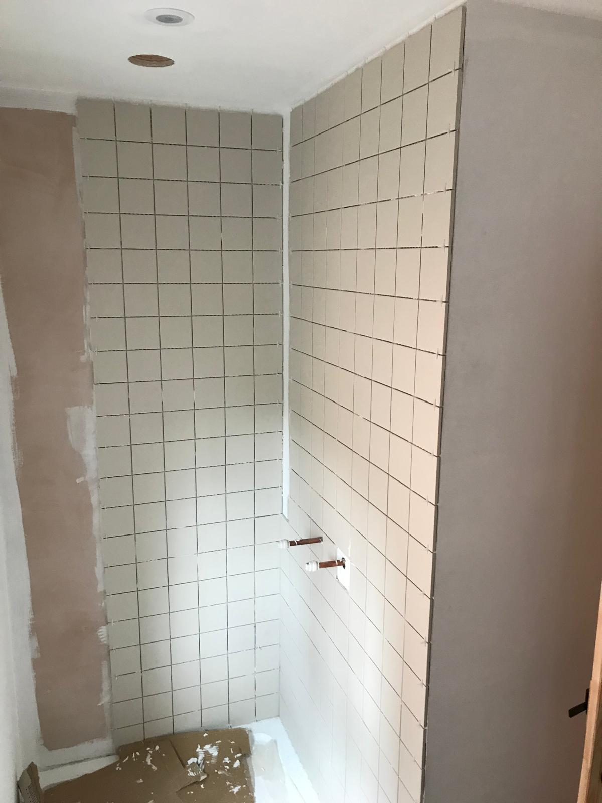 Shower area white square wall tile installation 