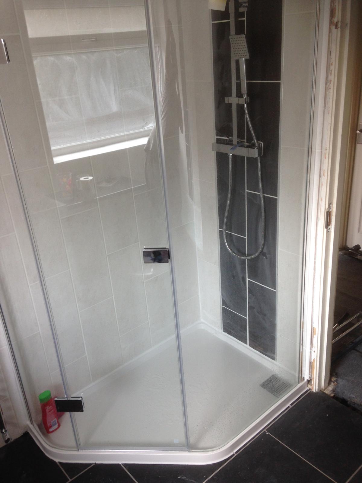 Shower installation with black and white wall tiles for a local project in Kent 
