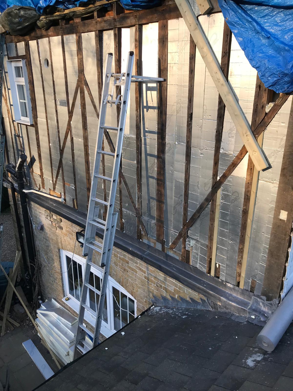 Side of house insulation installation in preparation of cladding installation